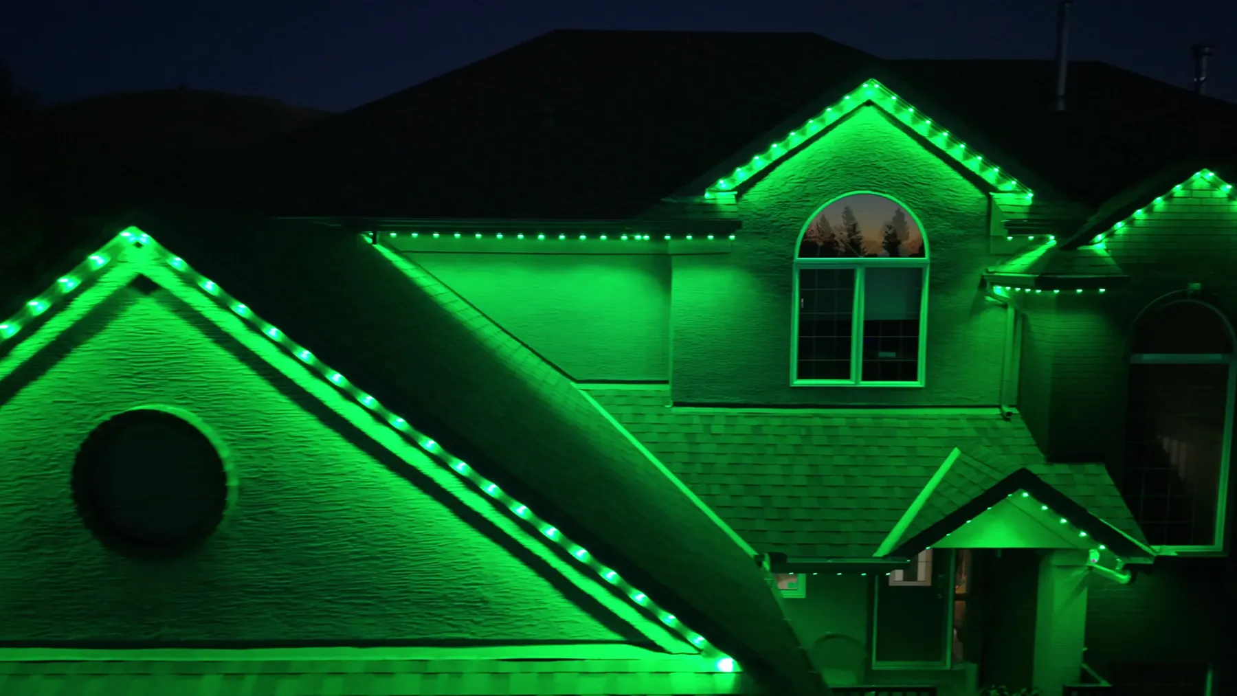 The same house lit in green